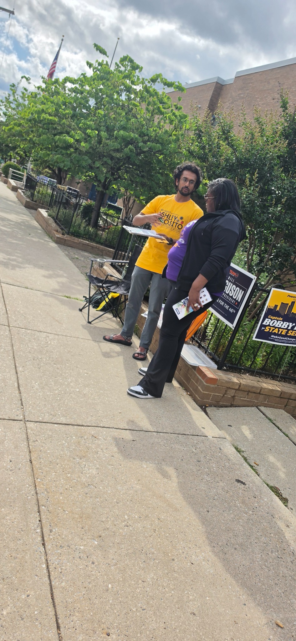 Martina Owens speaking with a campaign volunteer while working in the community